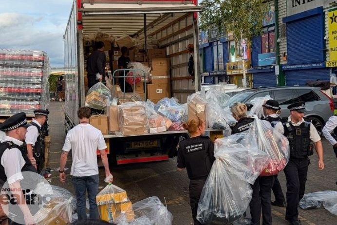 Officers from City of London and Met Policem, HMRC, and Ealing Trading Standards loading seized counterfeit goods onto a lorry
