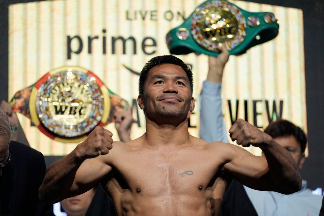 Manny Pacquiao poses on the scale during a ceremonial weigh in Friday, July 18, 2025, in Las Vegas. (AP Photo/John Locher)