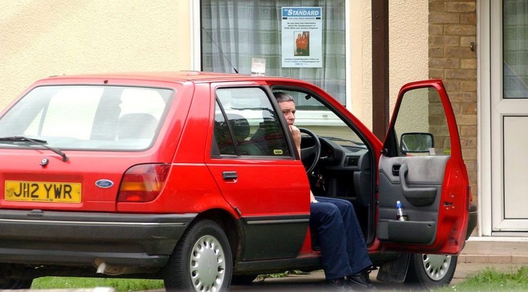 File photo dated 08/08/02 of caretaker Ian Huntley sitting in his car outside his house near the college in Soham, Cambs, during the period when police were looking for 10-year-old Holly Wells and Jessica Chapman. Soham killer Ian Huntley has died in hospital after he was attacked in the workshop of the maximum security Frankland prison by an inmate with a metal bar on February 26, the Press Association understands. Issue date: Saturday March 07, 2026. PA Photo. Photo credit should read: Andrew Parsons/PA Wire