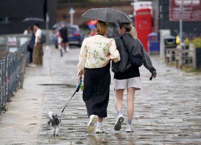 A couple walk along the promenade in Folkestone, Kent, during a shower of rain. The UK will see showers over the coming days but the rain is ???not going to solve the drought situation overnight???, a forecaster has said. Picture date: Wednesday August 19, 2026. PA Photo. Photo credit should read: Gareth Fuller/PA Wire