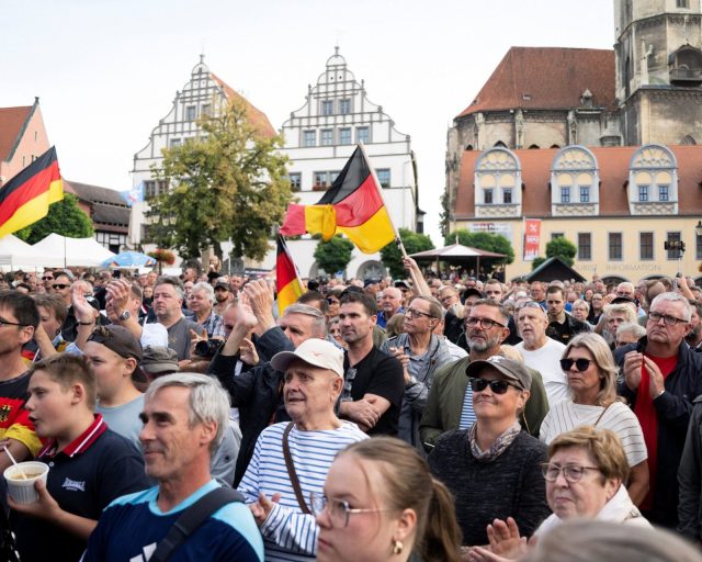 People look on during a campaign rally of the Alternative for Germany (AfD) party ahead of Germany's Saxony-Anhalt state election, in Naumburg, Germany August 24, 2026. REUTERS/Annegret Hilse