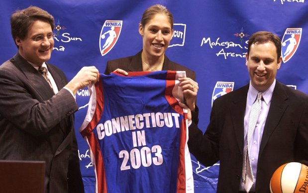 Rebecca Lobo, center, holds up a Connecticut Sun jersey with Mitchell Etess, left, vice president of marketing at Mohegan Sun, and Christopher Sienko, right, general manager of the Connecticut Sun, during a news conference announcing Lobo's signing to the team Friday, Feb. 14, 2003, at the Sun Arena in Uncasville, Conn. The Sun acquired Lobo from the Houston Comets in exchange for a second-round draft pick. (AP Photo/Norwich Bulletin, Rory Glaeseman) 