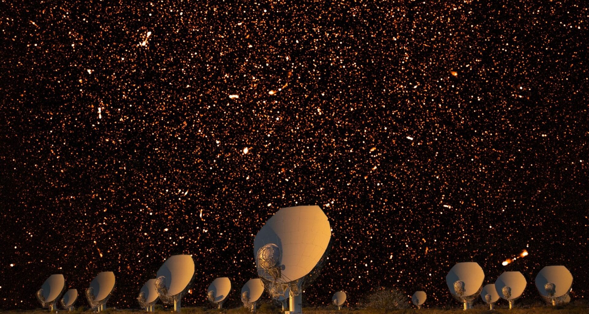 The MeerKAT array at night in South Africa, with bright radio sources represented in the night sky. Credit: SARAO