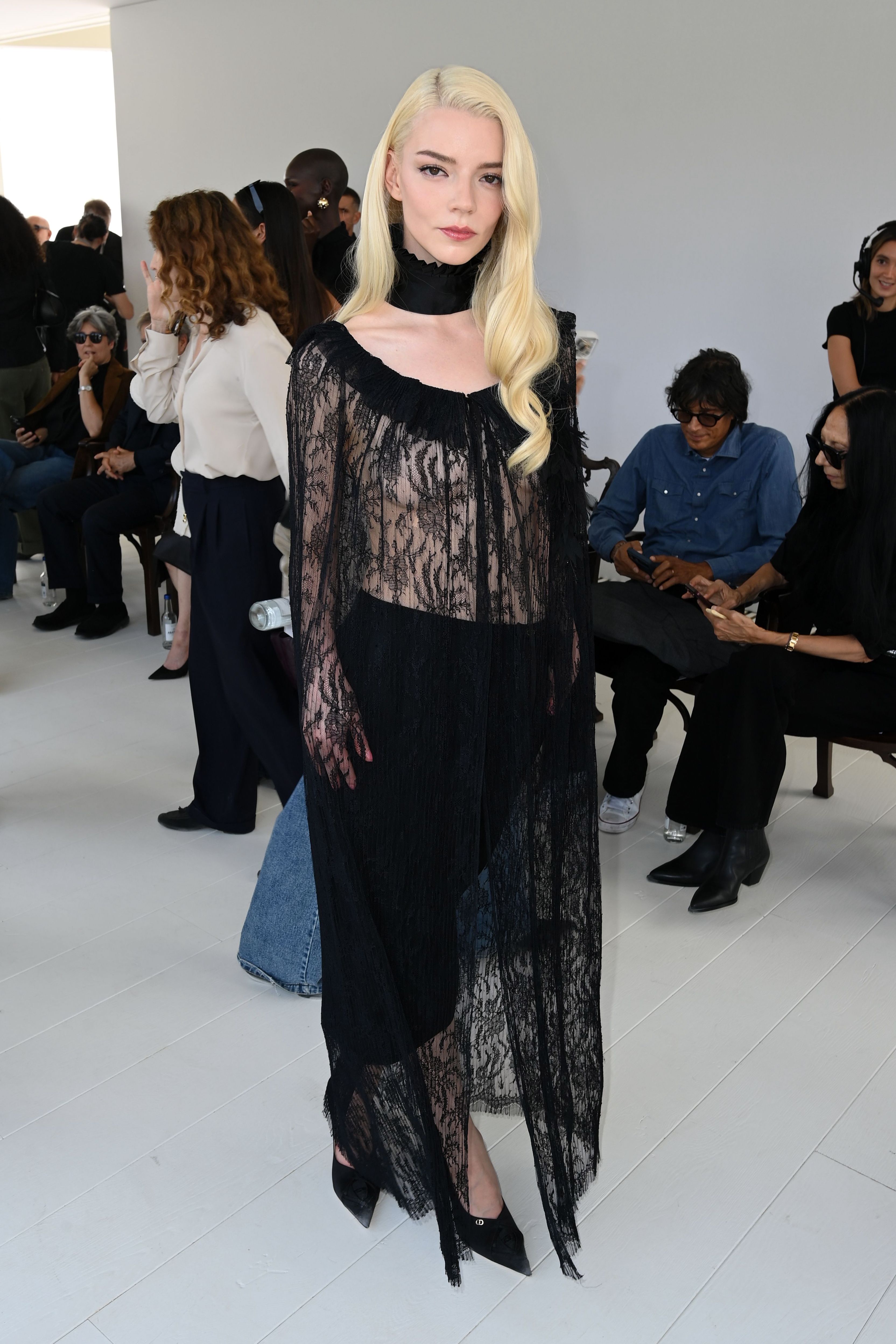 Anya Taylor-Joy in the front row of the Christian Dior show, in a sheer black lace top and long skirt.
