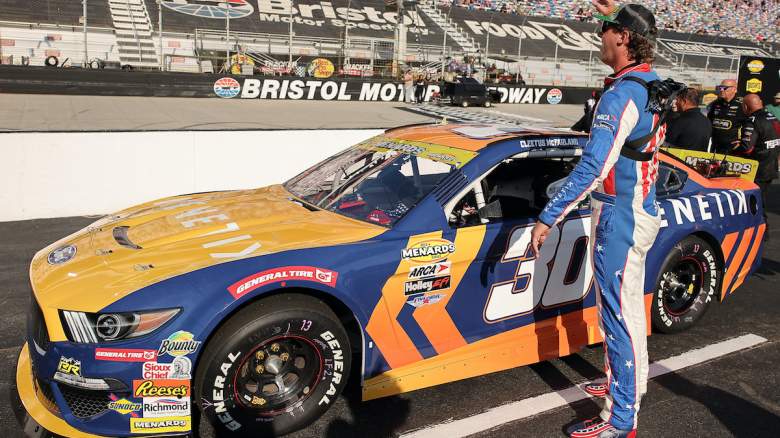 Garrett Mitchell, also known as Cleetus McFarland, driver of the #30 Kenetik Ford waves to fans