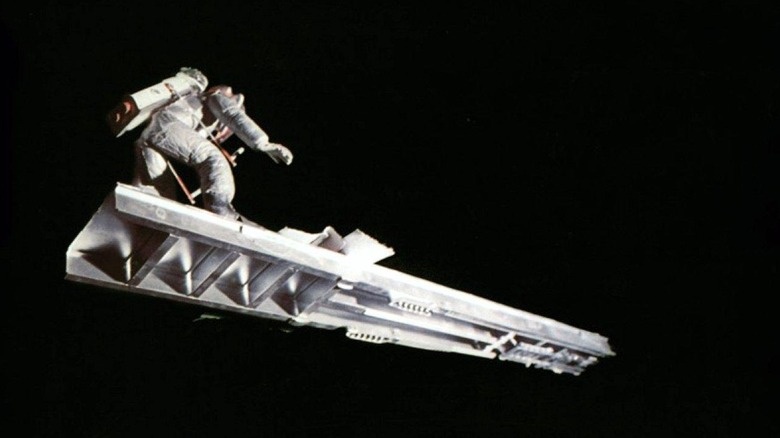 Brian Narelle as Lieutenant Doolittle in Dark Star, surfing through space on a piece of spaceship wreckage.