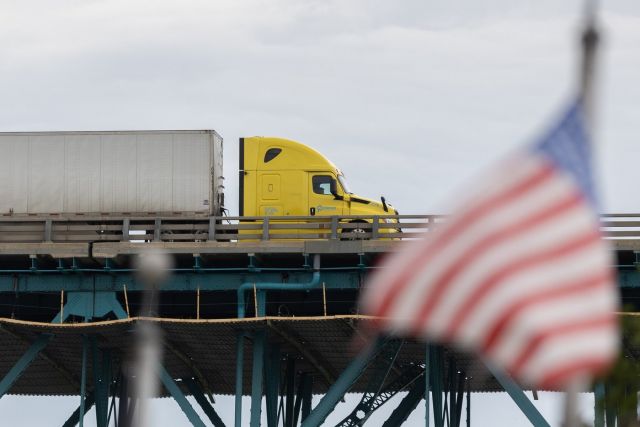 A transport truck crosses the Ambassador Bridge into the United States, in Windsor, Ont., Saturday, Aug. 22, 2026. THE CANADIAN PRESS/Dax Melmer