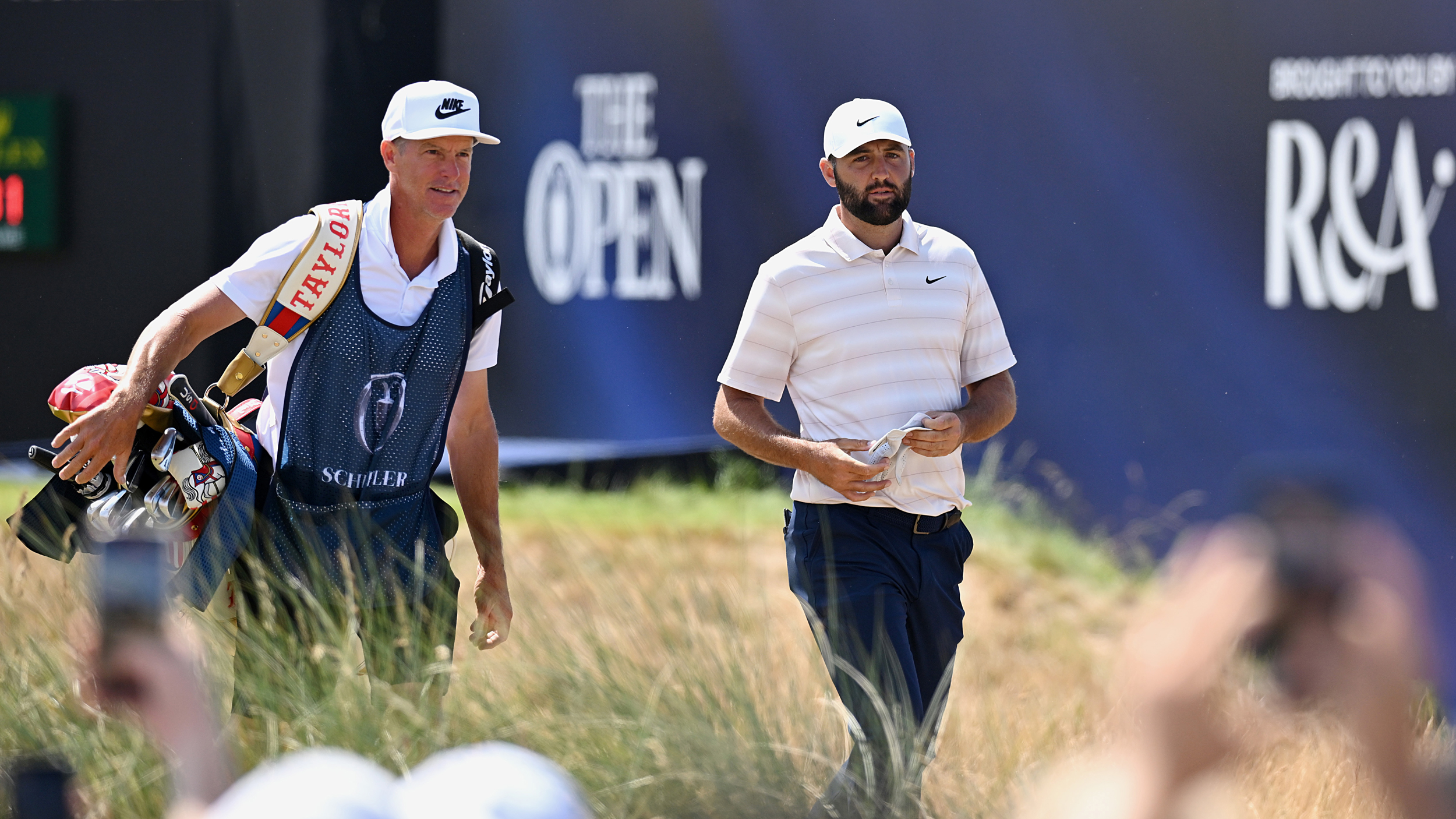 Scottie Scheffler and his caddie walk at The Open