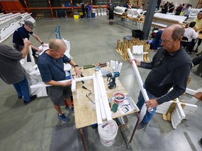 Volunteers cleaning and repairing crosses for the Field of Crosses