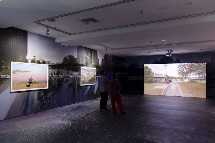 Two photos and a video work in a gallery.