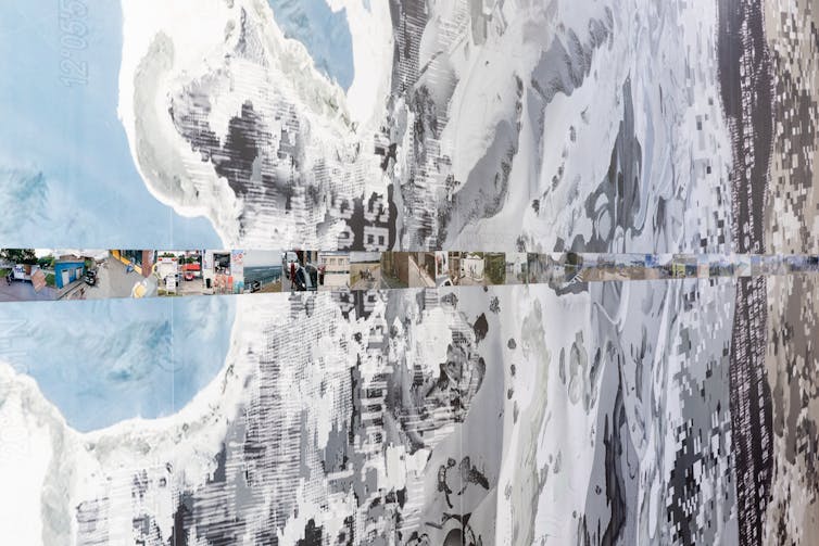 A line of photographs on a wall.