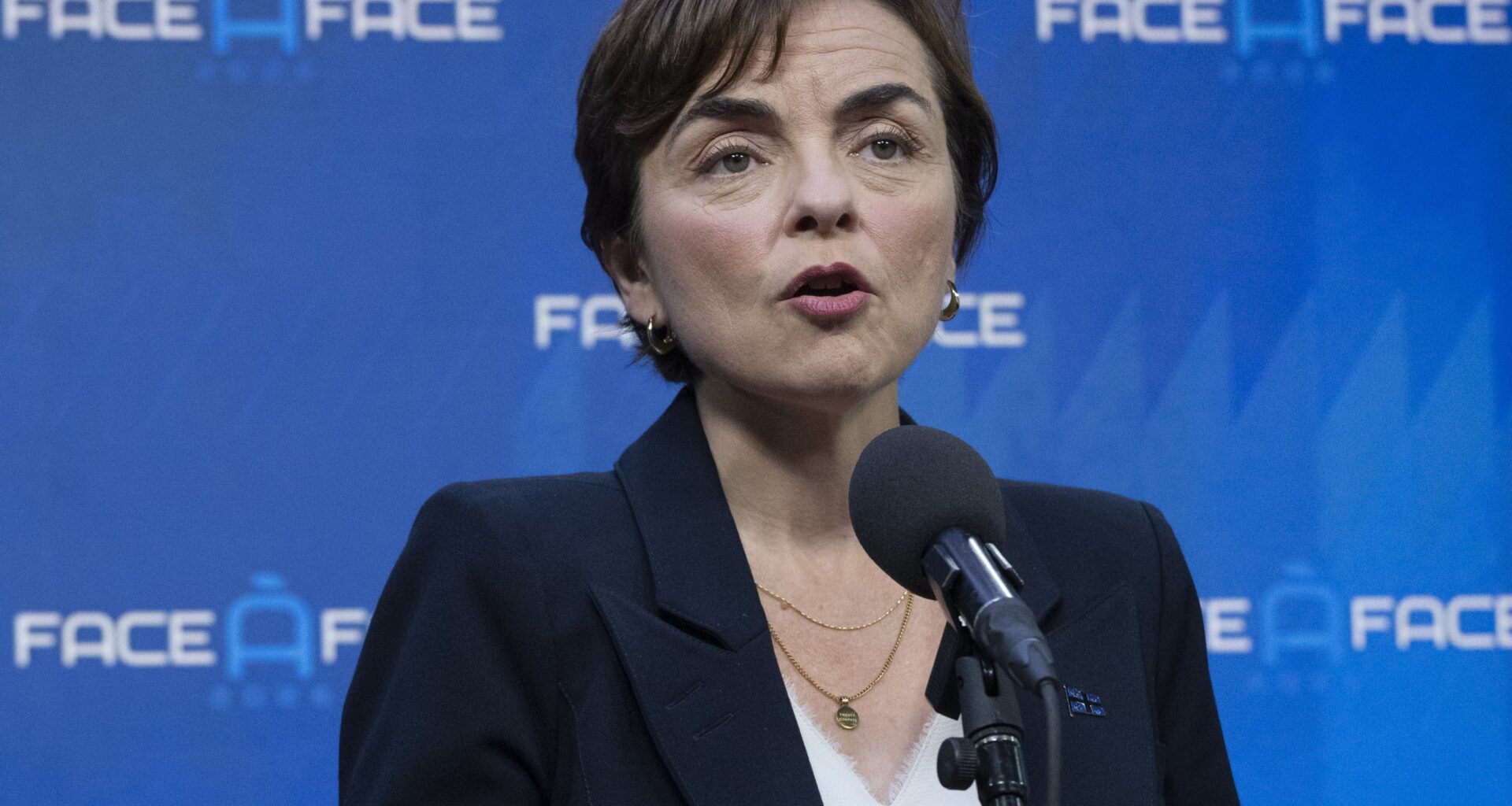 Woman speaks into microphone.