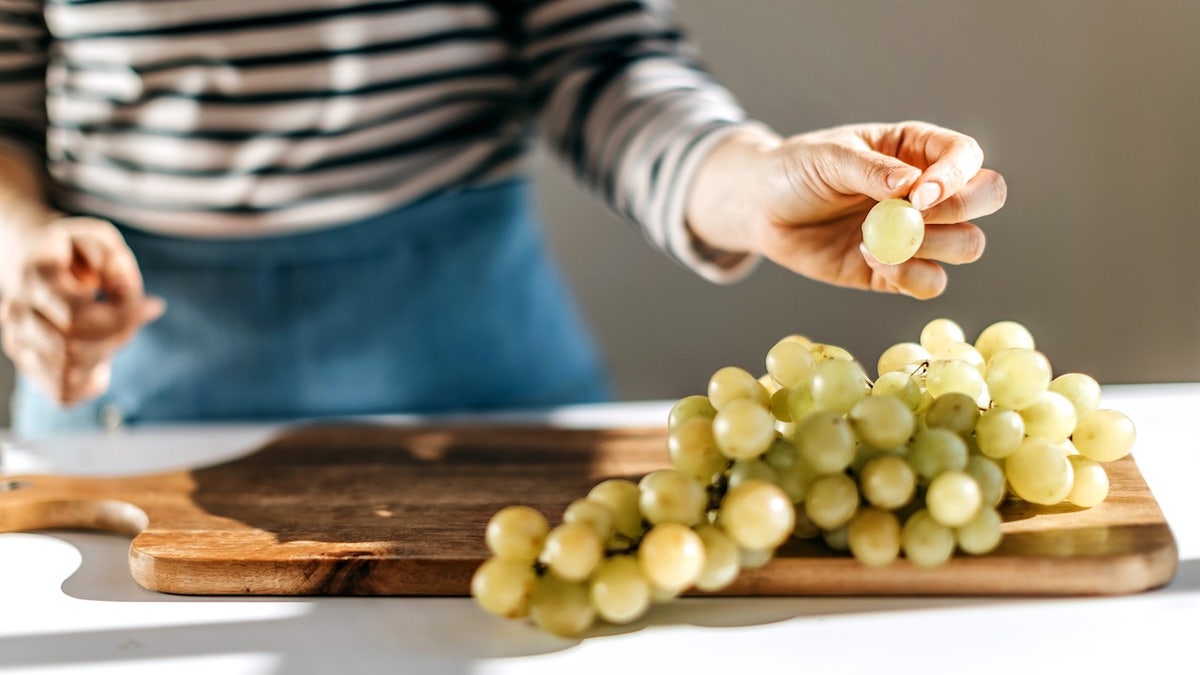 Woman eating grapes