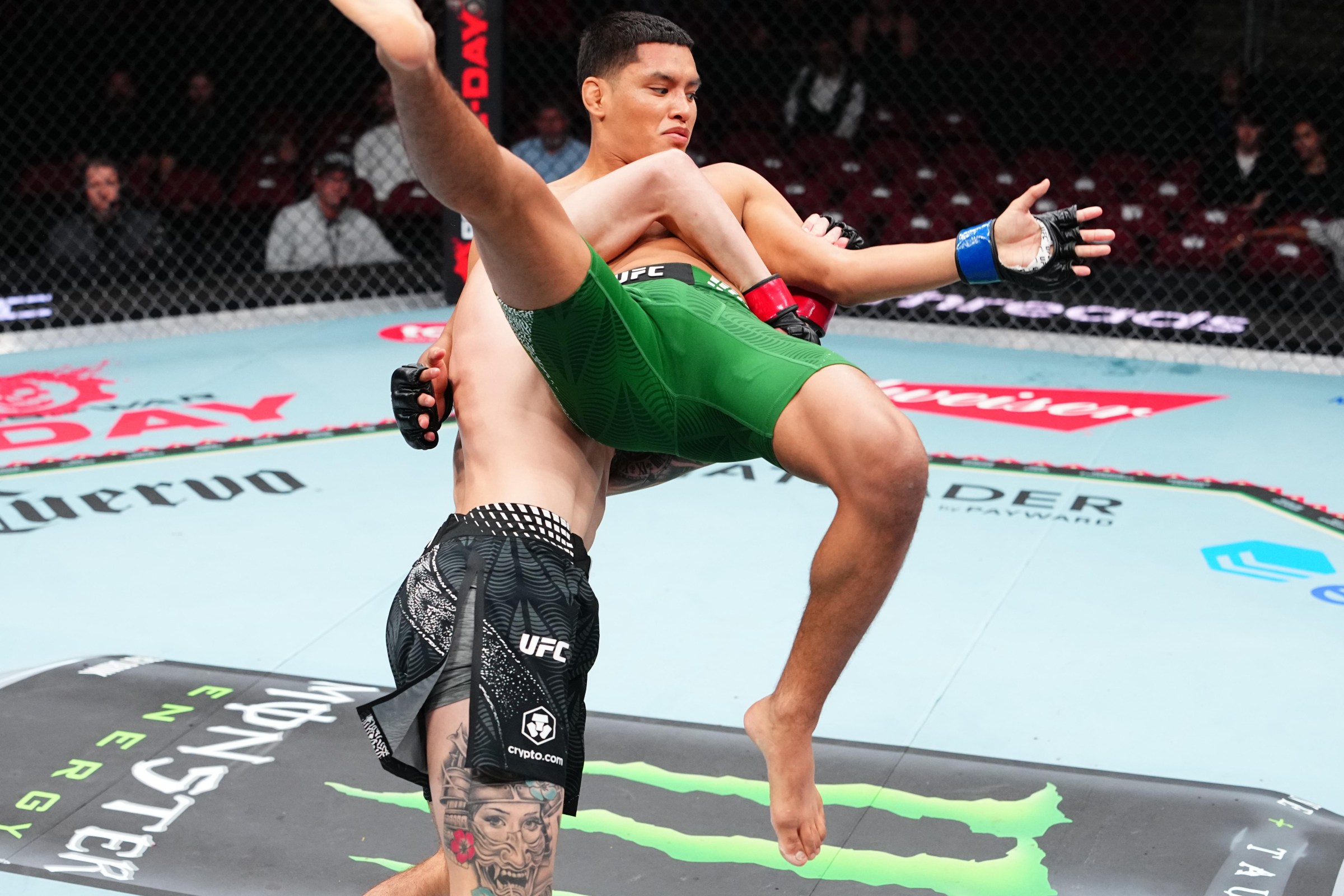 GLENDALE, ARIZONA - SEPTEMBER 12: (L-R) Sean King III lifts Jessie Rosas in their featherweight fight during the Noche UFC event at Desert Diamond Arena on September 12, 2026 in Glendale, Arizona. (Photo by Jeff Bottari/Zuffa LLC)