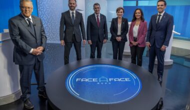 Five party leaders stand near Paul Larocque in a TV studio posing for a photo.