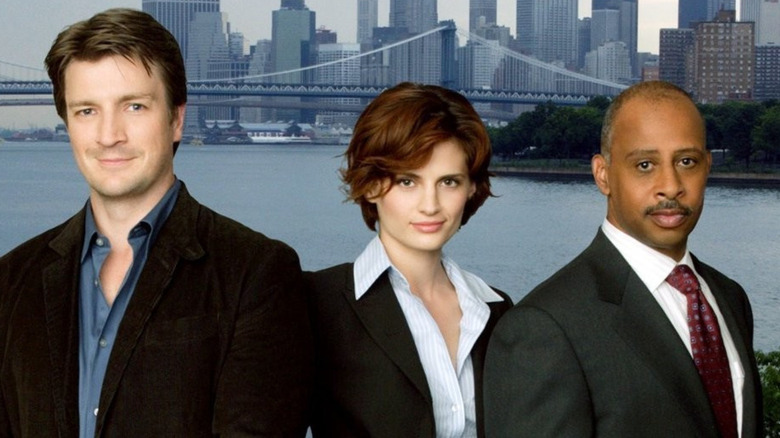 Nathan Fillion, Stana Katic, and Ruben Santiago-Hudson pose for a poster for Castle.