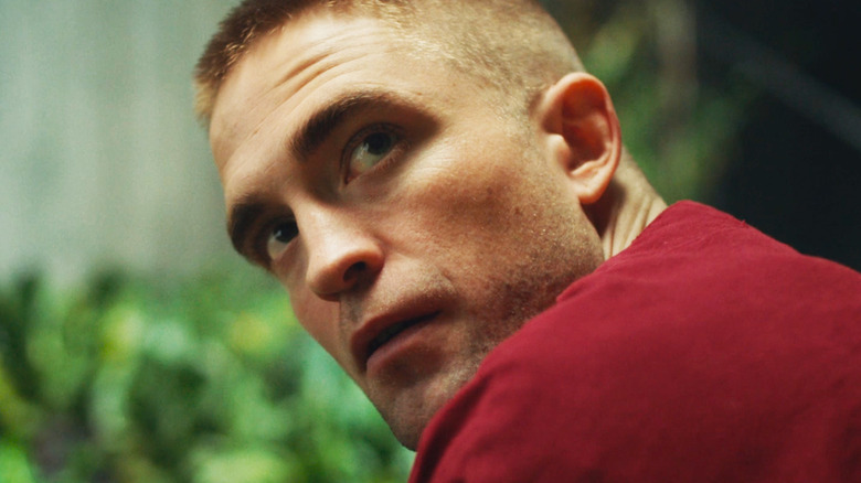 Robert Pattinson's Monte looks up as he crouches in High Life