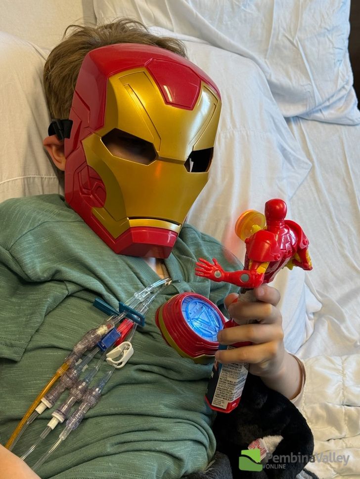 Maverick with an Iron Man mask on playing with action figures