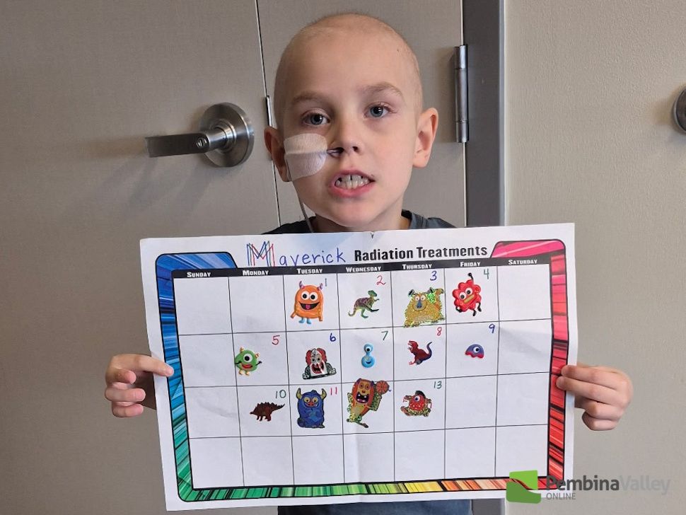 Maverick holding a cancer treatment sticker chart