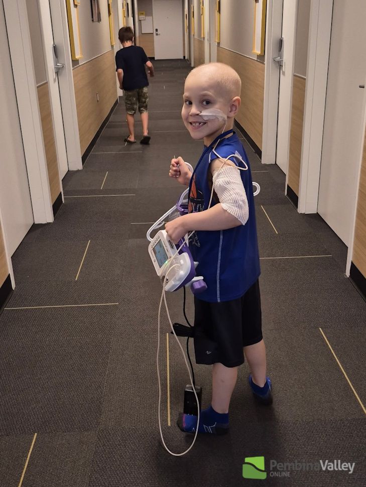 Maverick Friesen walking down the hall of the hospital