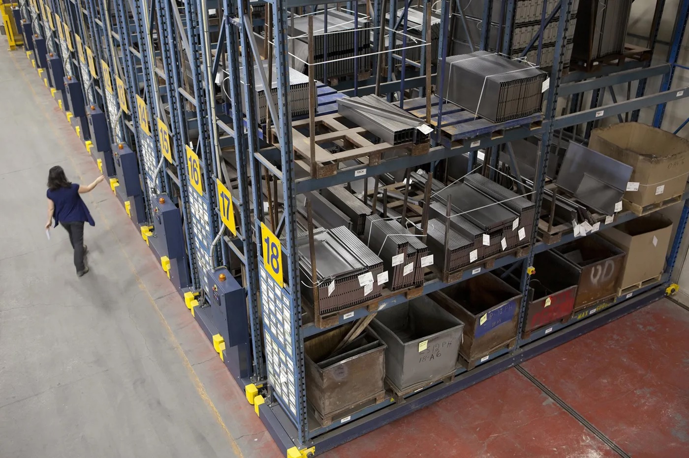 Large industrial shelves are seen from a high angle in a warehouse.