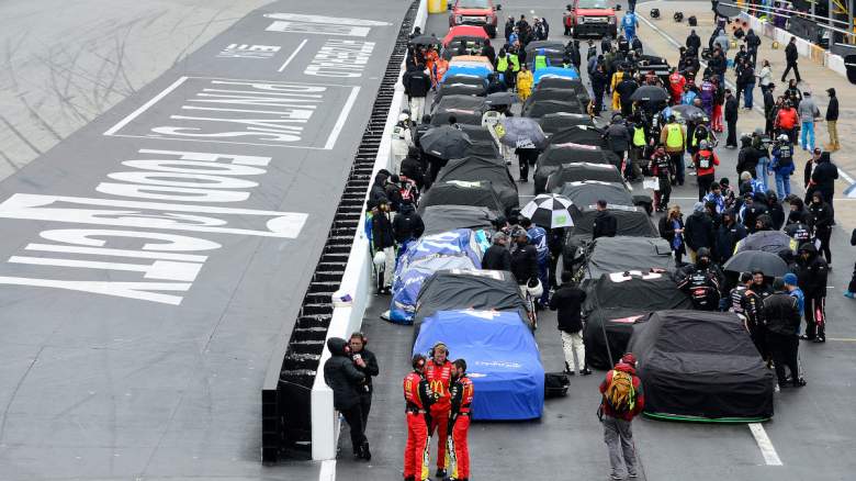 Cars are covered in the pit lane.