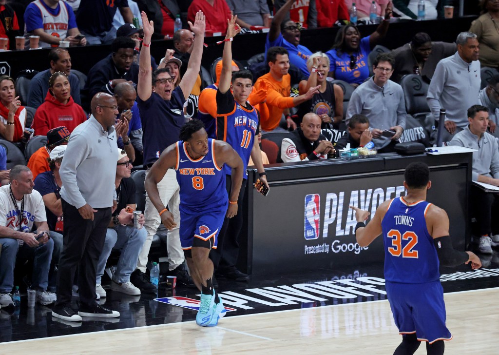 New York Knicks forward OG Anunoby (8) in a blue jersey during the first quarter of an NBA Playoffs game, with fans reacting in the background.