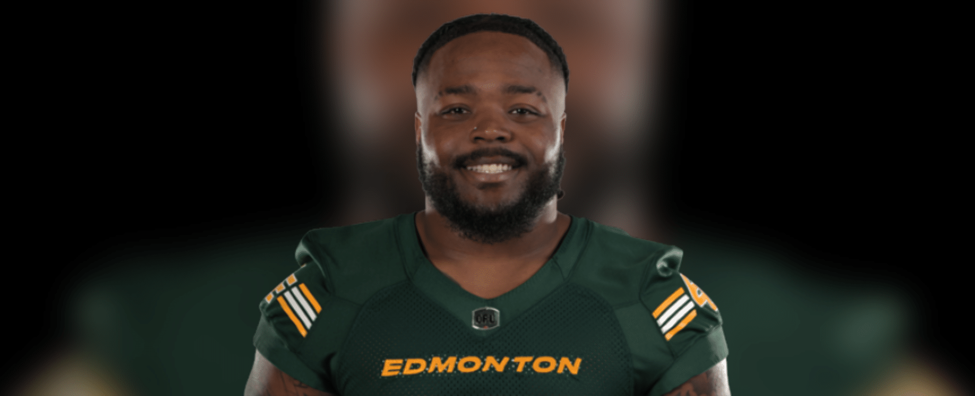 Nick Anderson smiling in Edmonton Elks uniform, showcasing his leadership in football.