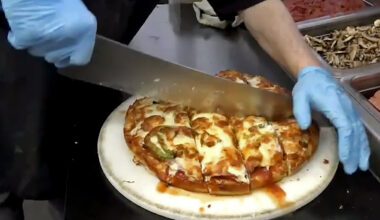 A pizza being cut at Tumblers Pizza in Regina.