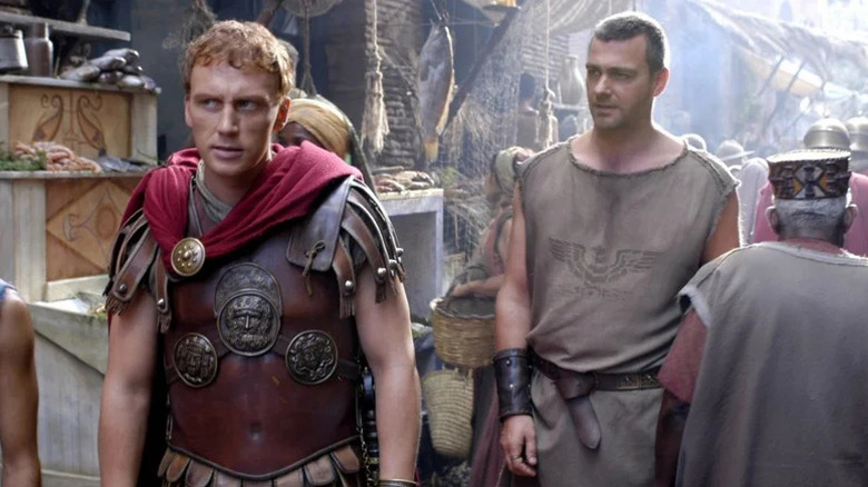 Kevin McKidd in armor as Lucius walking down street next to Ray Stevenson as Titus in Rome.