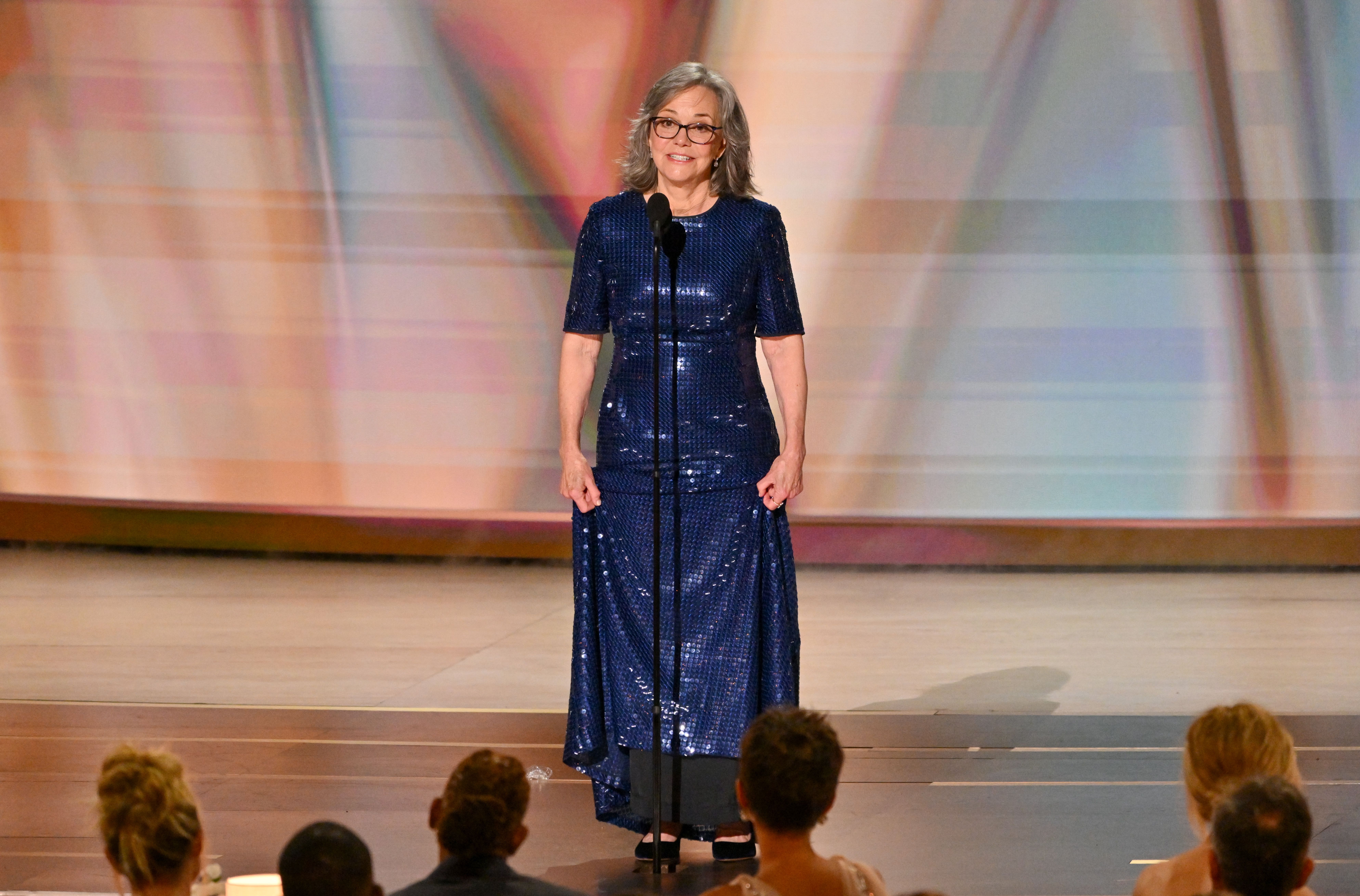 Sally Field speaking at the 78th Primetime Emmy Awards, wearing a blue sequined dress.