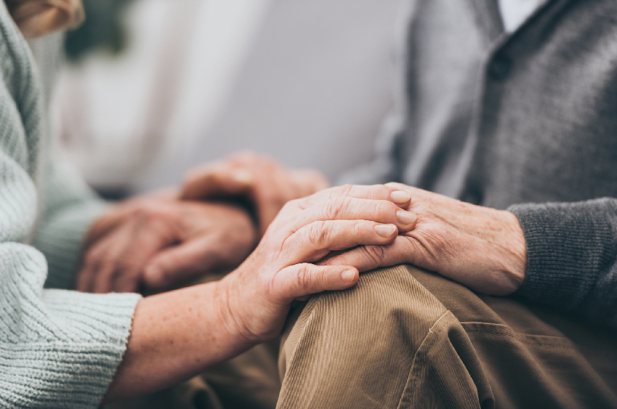 Cropped view of retired couple holding hands
