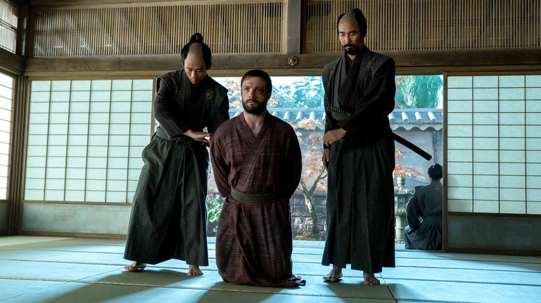 John Blackthorne kneels besides two samurai in 