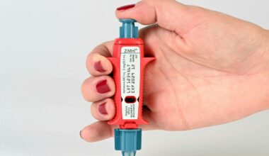 a hand holding a small bottle of nail polish