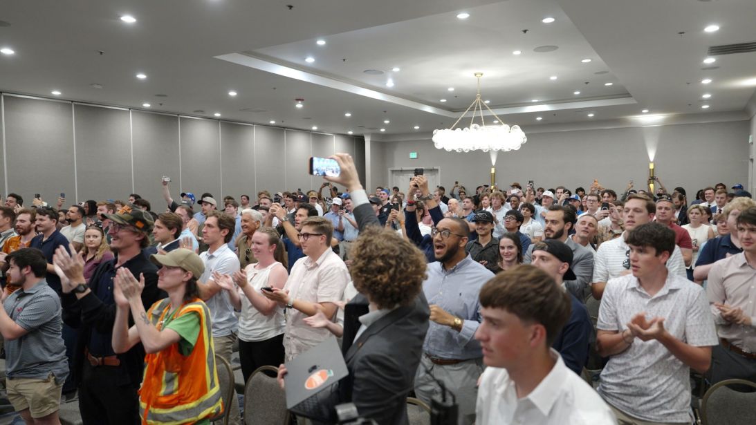 An audience of mostly young men gathers in Dallas last month to hear James Fishback, a right-wing “America First” activist who has been critical of Trump’s war in Iran.