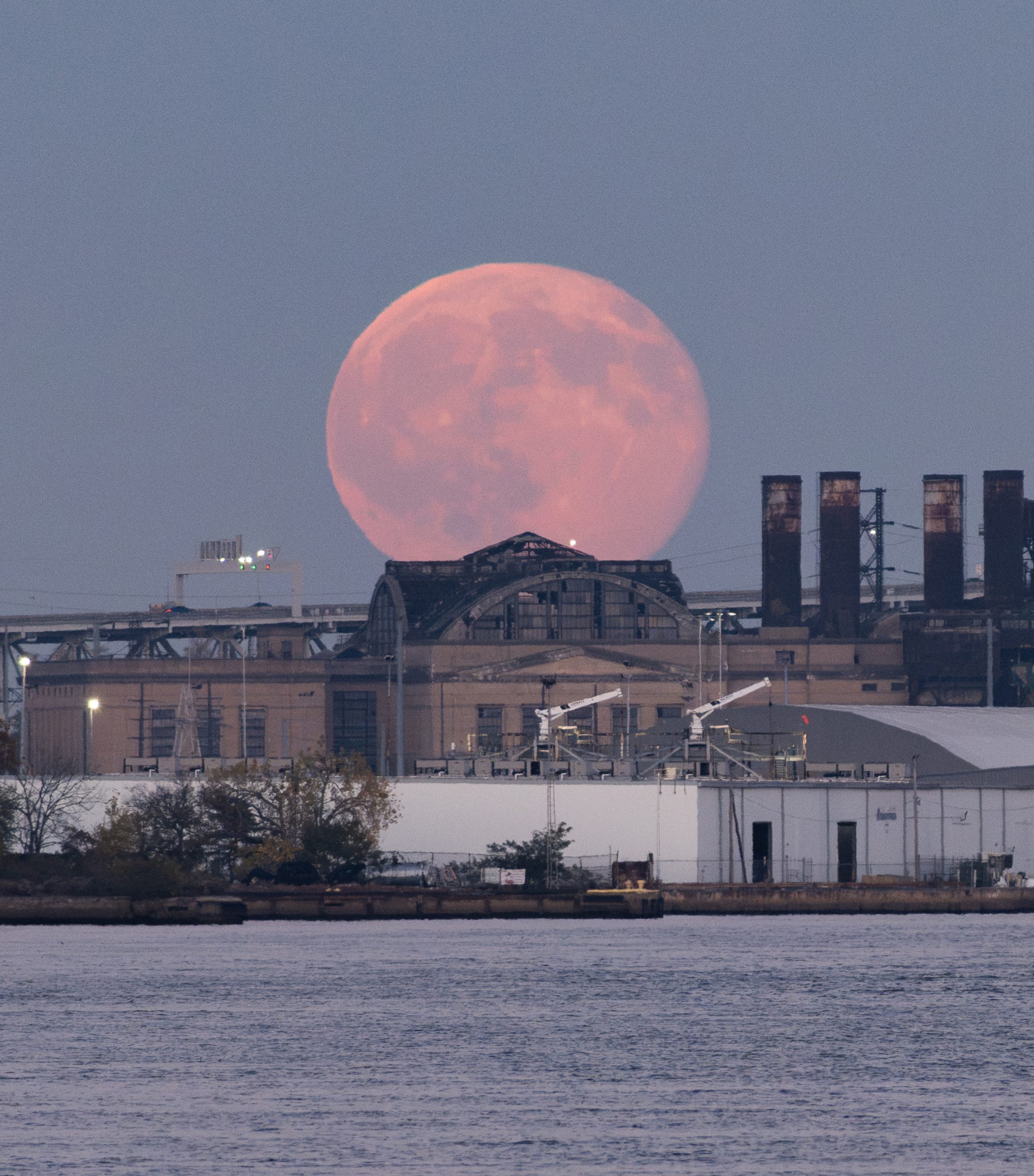 Hunter's Moon over an abandoned, power plant, Philadelphia, Pennsylvania, USA, captured by Matthew Royles, 26 October 2026. Equipment: Lumix S5 II camera, TTArtisan 500mm f/6.3 lens Exposure: ISO 3200, f/8, 1/320s Software: Lightroom