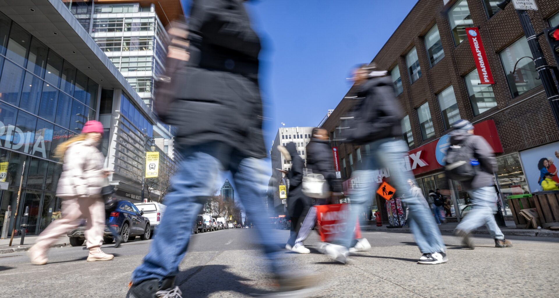 Pedestrians cross Ste-Catherine St.