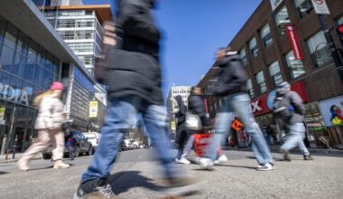 Pedestrians cross Ste-Catherine St.