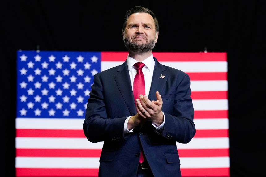 Vice President JD Vance applauds as he takes the stage during a midterm campaign rally in Monroe, Michigan, on October 15, 2026.