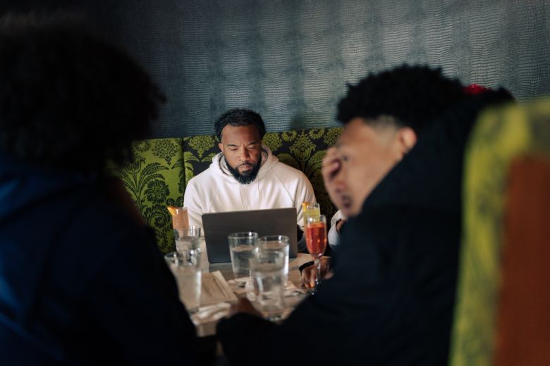 Geffrey works while eating with his family at a restaurant in Milwaukee, Wisconsin, on May 13, 2026.