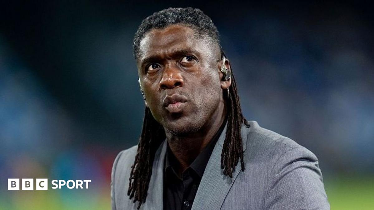 Clarence Seedorf working as a pundit before Napoli's Champions League match against Arsenal in September, in grey jacket and black shirt