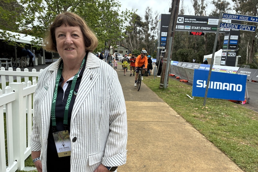 Vicki Hansen in Nannup with a cyclist in the background.