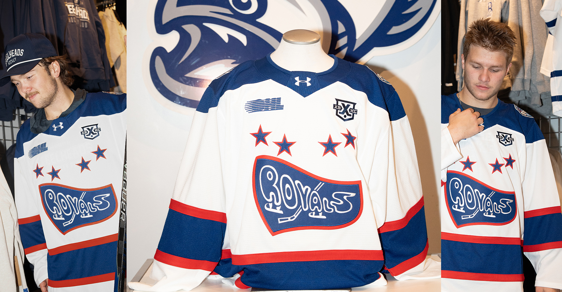 Two hockey players with Cornwall Royals jerseys standing beside a manikin also wearing a jersey
