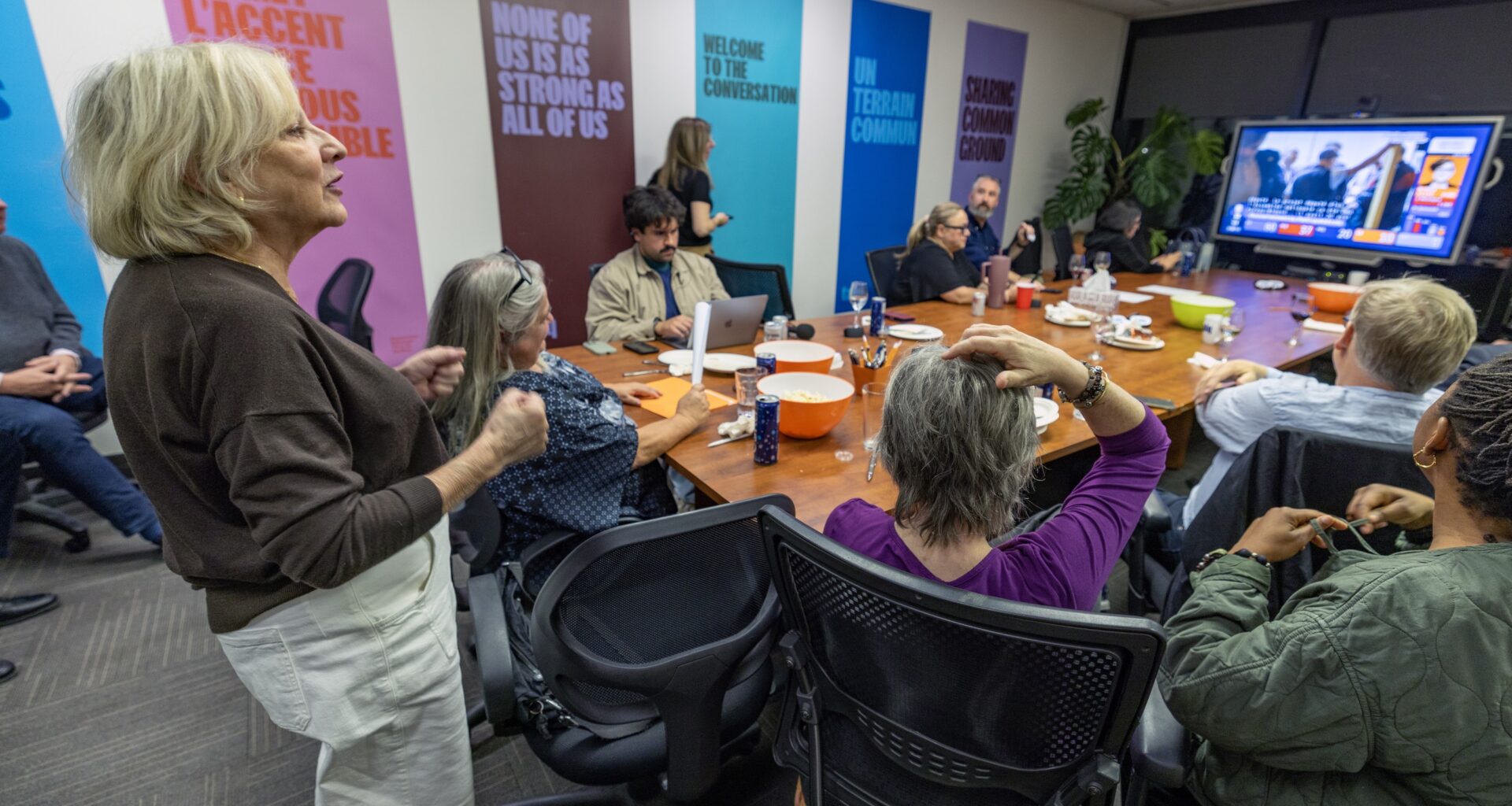 TALQ director general Sylvia Martin-Laforge, left, joins members watching the provincial election results at their office in Montreal on Monday night.