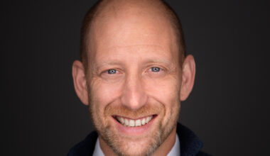 A man smiles in a promotional photo