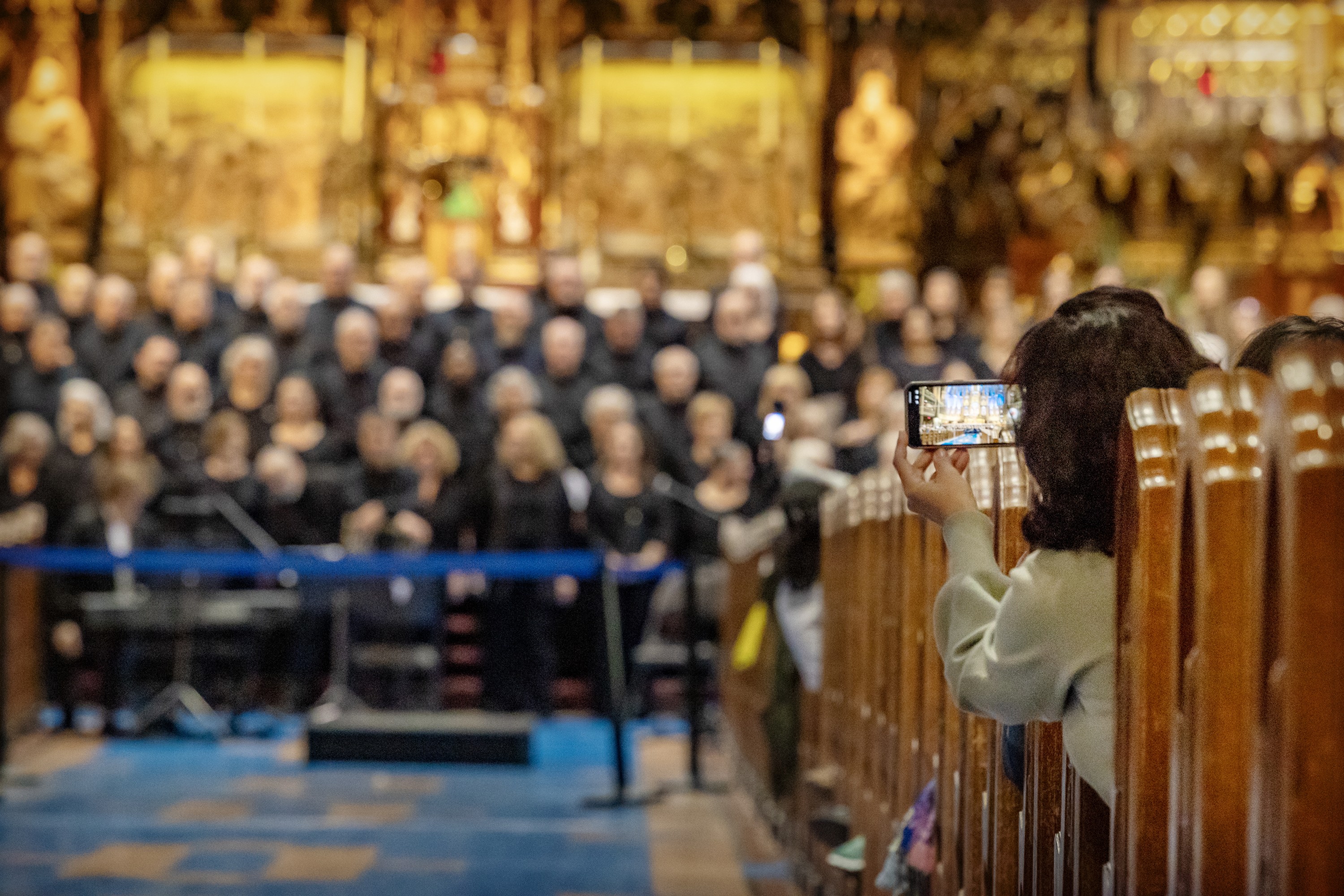 A visitor takes a photo of a choir inside Montreal's Notre-Dame Basilica