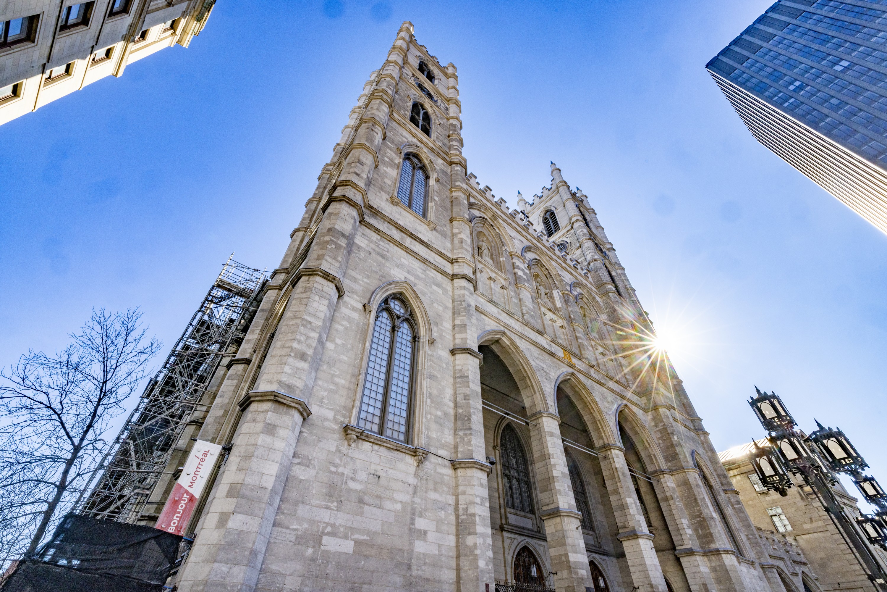 The sun peeks around Montreal's Notre-Dame Basilica