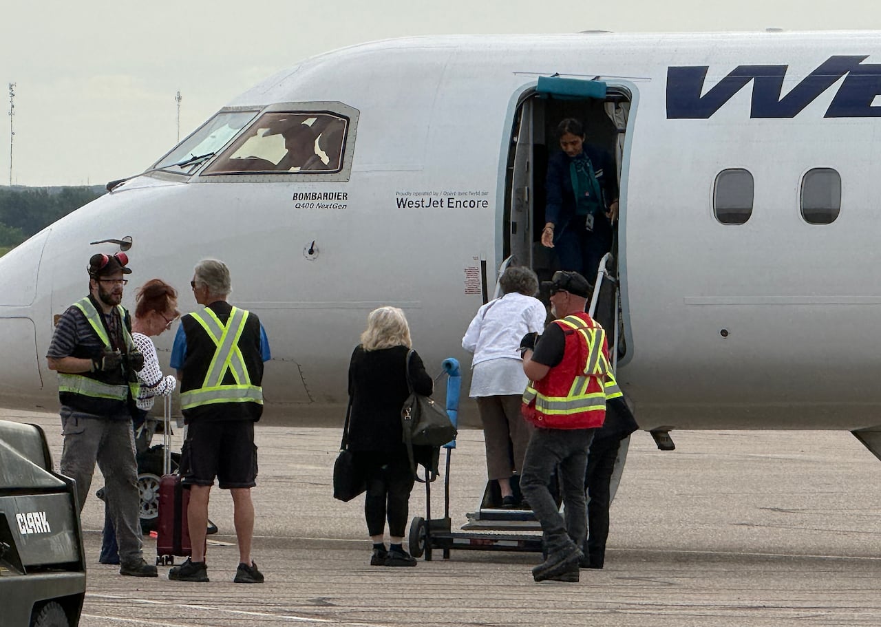 Passengers board a plan from the tarmac at Medicine Hat regional airport in a file photo.