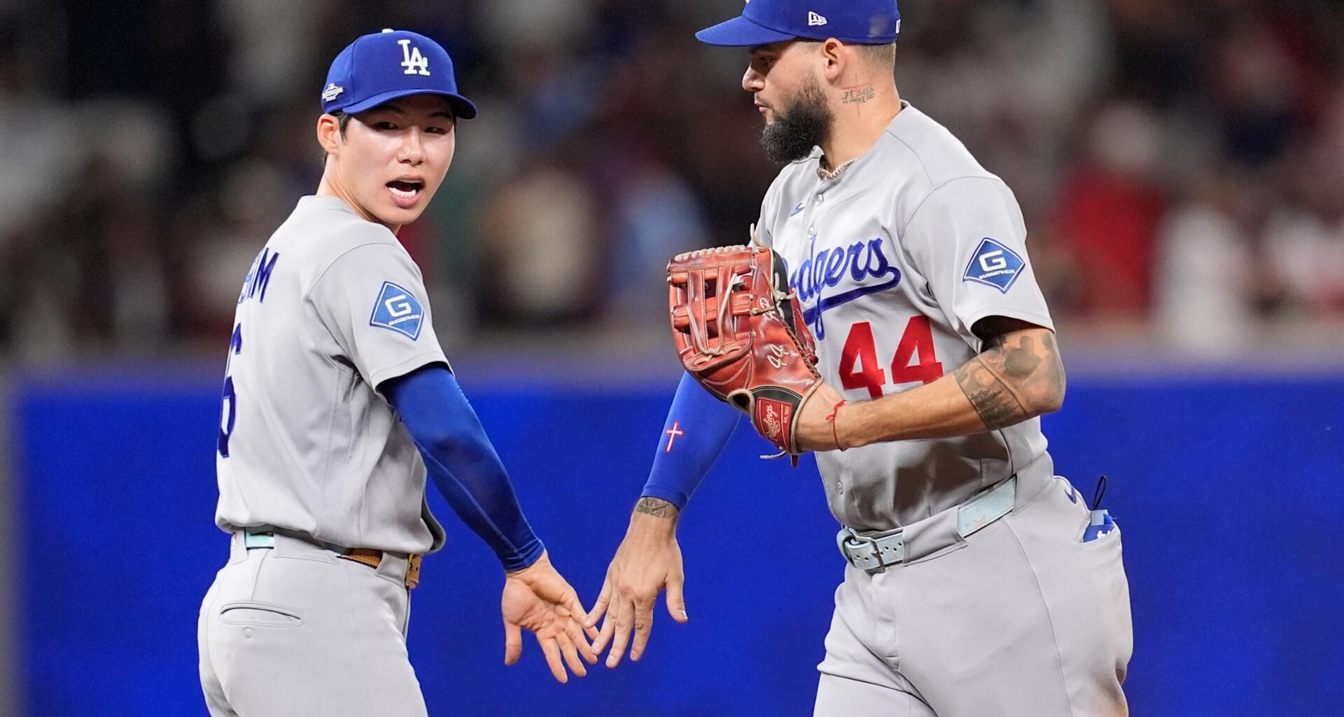 Los Angeles Dodgers shortstop Kim Hye-seong  and Los Angeles Dodgers center fielder Andy Pages celebrate winning Game 4 of baseball