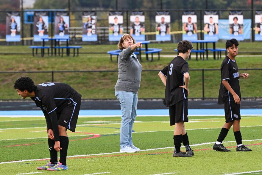 Sherry Nolan, assistant coach for the Wilkes-Barre Area boys soccer team, helps players prior to Monday's game.